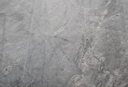 Close-up of a textured grey stone surface suitable for backgrounds or wallpapers.