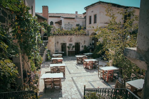 Rustic courtyard with vintage architecture and outdoor seating, perfect for dining.