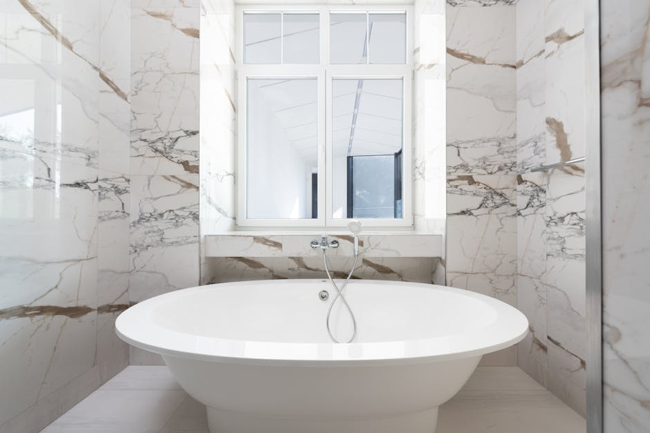 pexels-photo-8146153-8146153 Luxurious marble bathroom featuring a sleek freestanding bathtub and modern design elements.